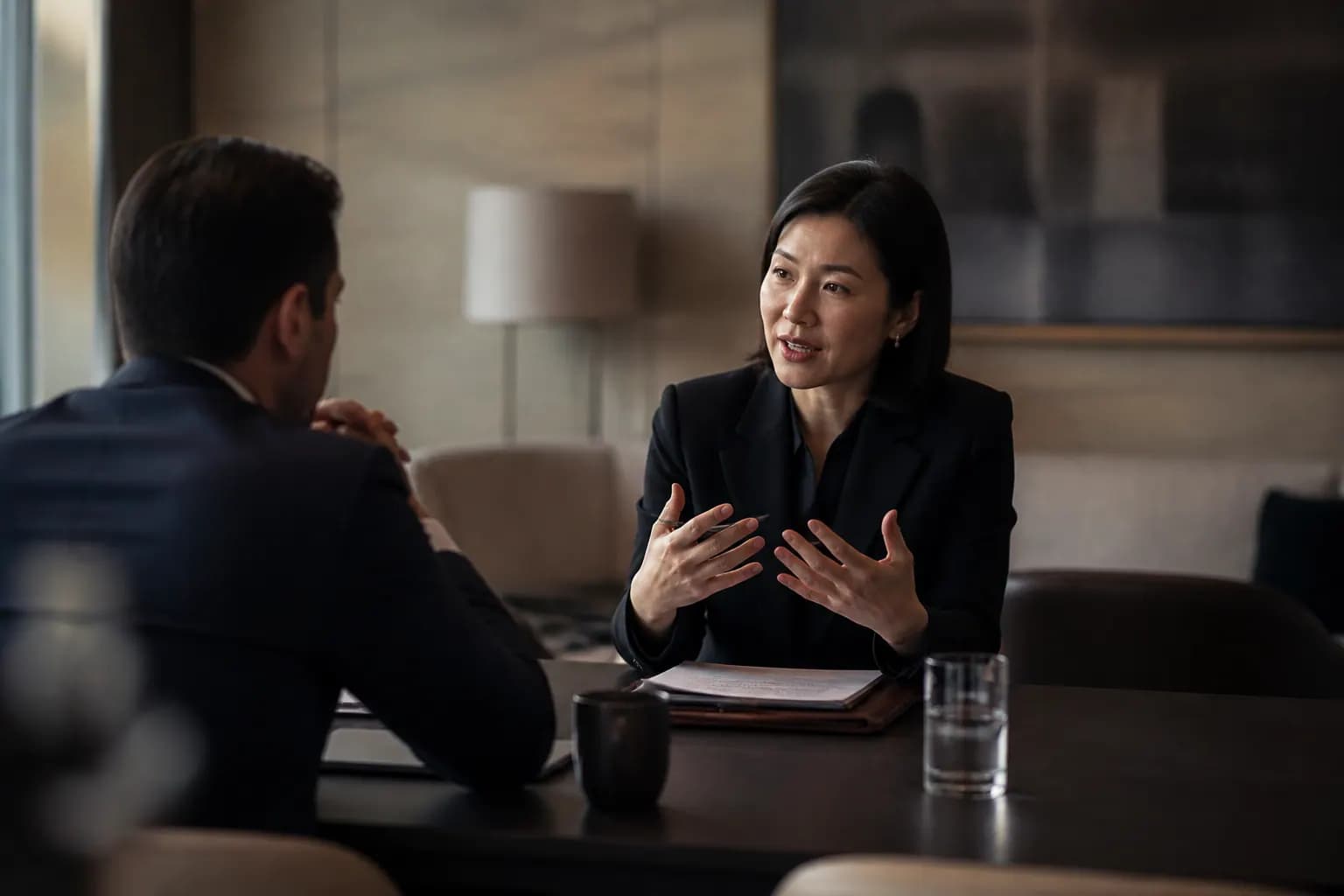 Analysts reviewing financial due-diligence documents at a desk.
